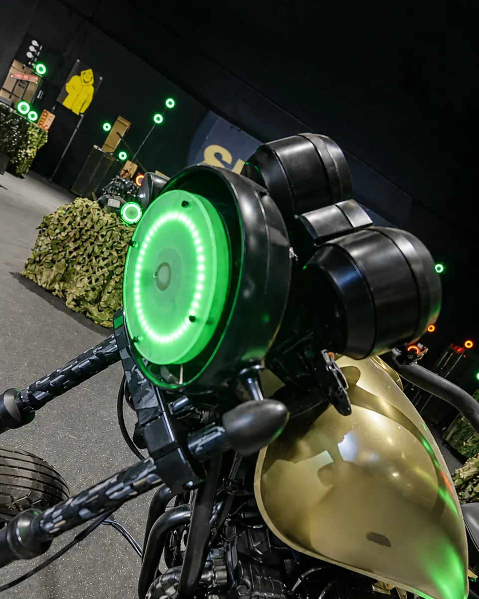 A glowing green ring target mounted on a motorcycle